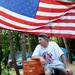 Camp Take Notice resident Jimmy Hill takes a break on a stack of plastic milk crates and underneath a larger American flag erected by a fellow resident and veteran at the camp on Wednesday, June 20, 2012 in Ann Arbor, Mich. Hill received a voucher for an apartment but is still working out where he will live in the time before it is available. AP Photo/AnnAbor.Com, Melanie Maxwell